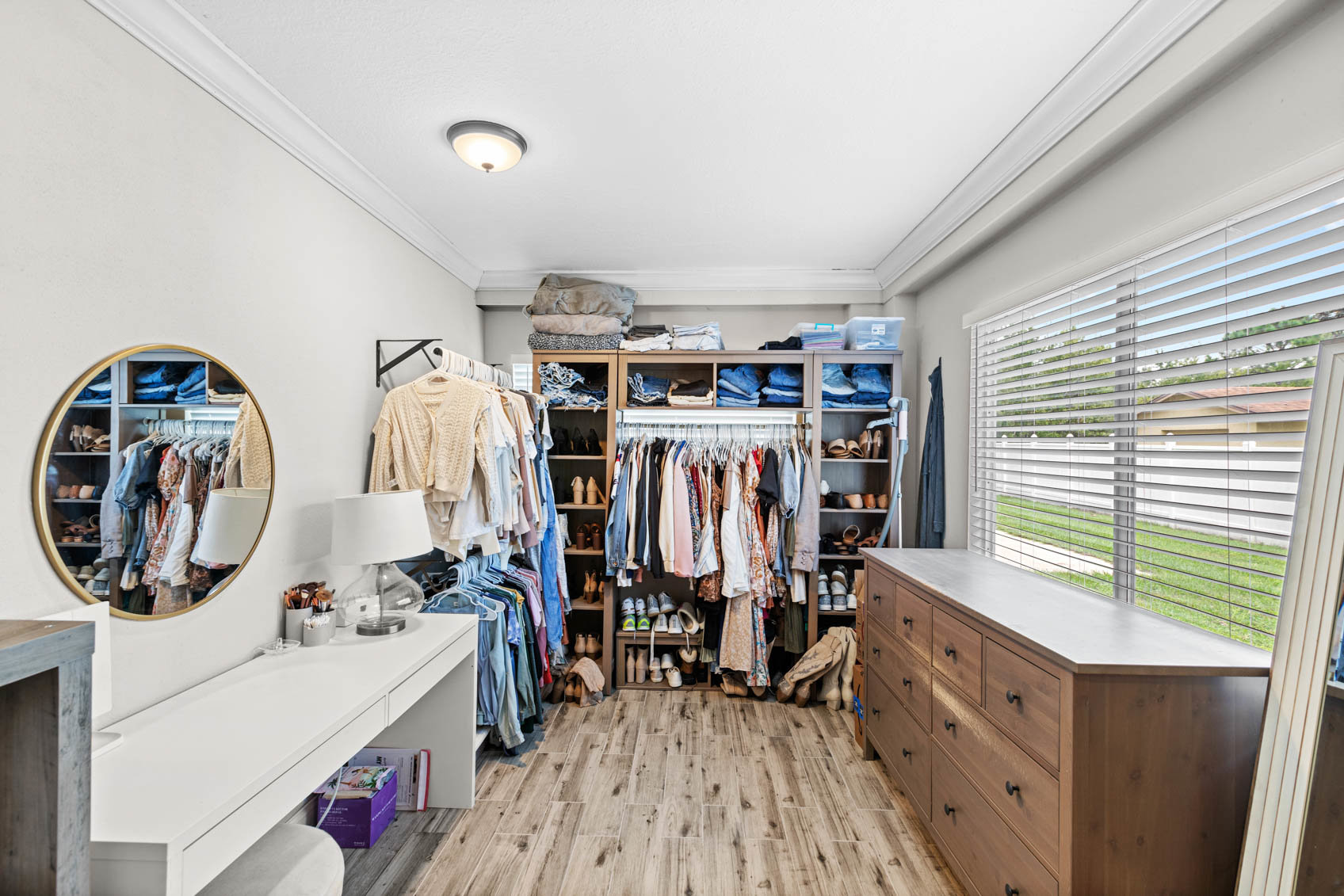 primary bedroom walk in closet with window